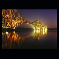 iron metal train transport travel history historic historical construction industry industrial yellow orange dark blue purple night sky
 skies water engineering crossing spanning span over structure  Scottish photographs Doug Houghton