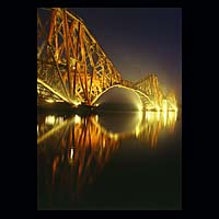 iron metal train transport travel history historic historical construction industry industrial yellow orange dark blue night sky skies
 water engineering crossing spanning span over structure  Scottish photographs Doug Houghton